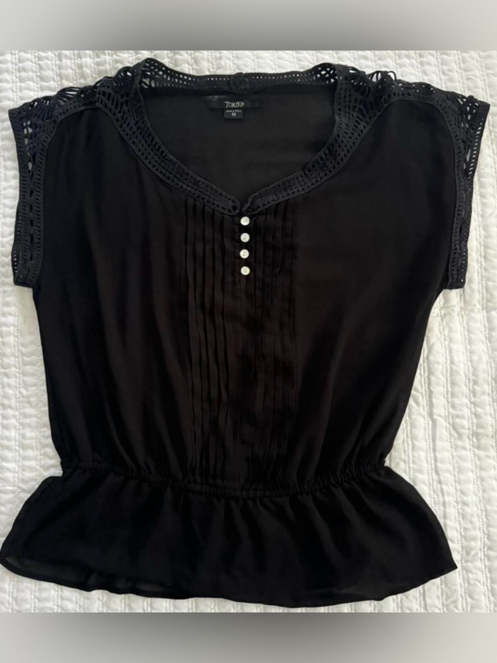 Black sheer blouse with crochet style details and elastic waistband
